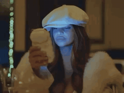 Woman In White Hat And Fur Coat Holding Remote Control GIF