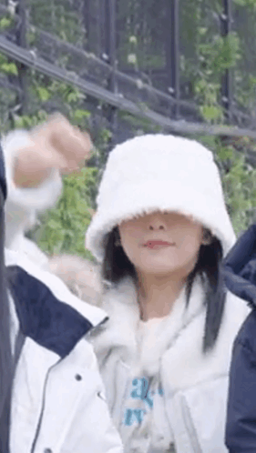 Woman In White Hat And White Jacket Standing Next To Man GIF