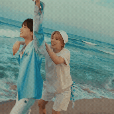 Woman In White Hat Carrying Woman On Beach GIF