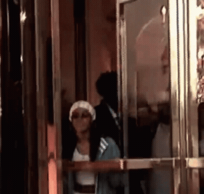 Woman in White Hat Standing in Doorway