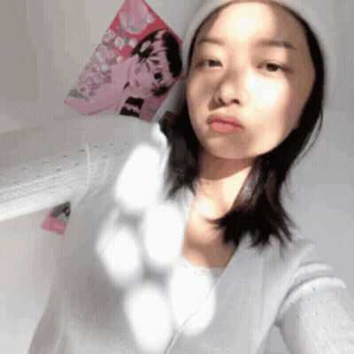 Woman In White Hat Taking Selfie In Front Of Pink Poster GIF