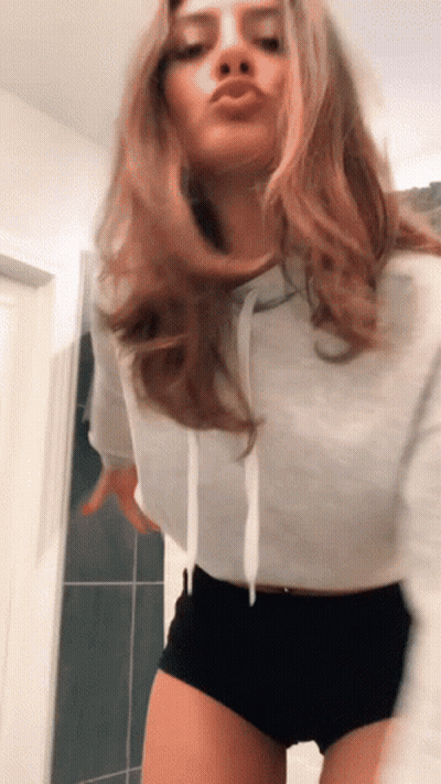 Woman In White Hoodie And Black Shorts Dancing GIF
