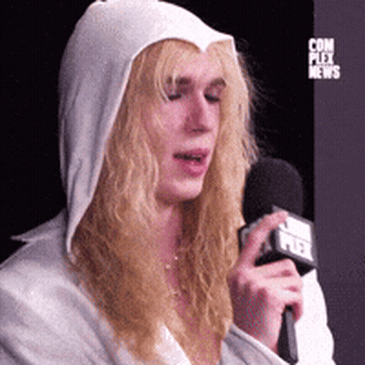 Woman In White Hoodie Holding Microphone With Fox News Logo GIF