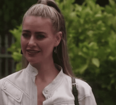 Woman In White Jacket And Earrings Smiling GIF