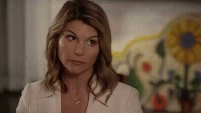 Woman In White Jacket And Necklace Looking Away GIF