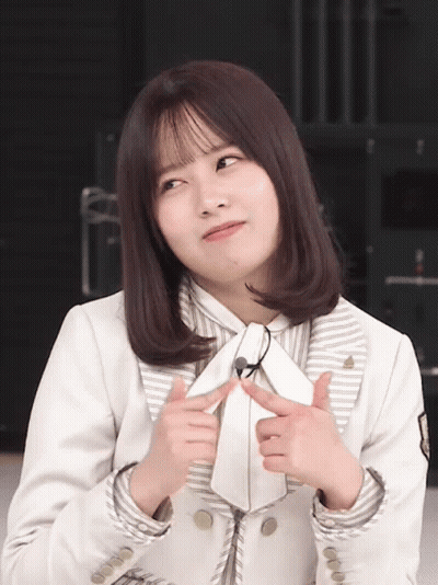 Woman In White Jacket And Tie Making Face GIF