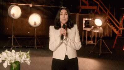 Woman In White Jacket At Microphone GIF
