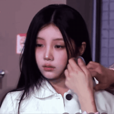 Woman In White Jacket Getting Hair Done By Man GIF