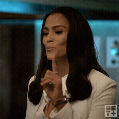 Woman In White Jacket Making Shhh Gesture GIF