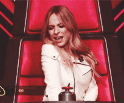 Woman In White Jacket Sitting In Red Chair GIF