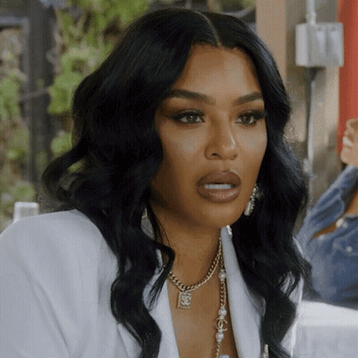 Woman In White Jacket With Chanel Pendant Necklace GIF