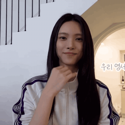 Woman In White Jacket With Purple Stripes Smiling GIF