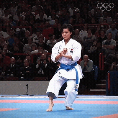 Woman In White Karate Uniform With Blue Belt GIF