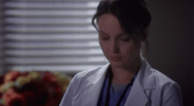 Woman In White Lab Coat Sitting By Window GIF