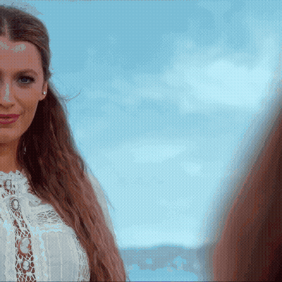 Woman In White Lace Top Looking At Camera GIF