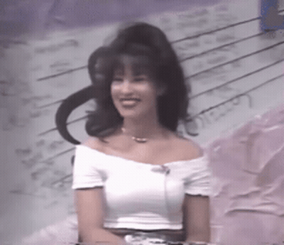 Woman In White Off-Shoulder Top Smiling At Piano GIF