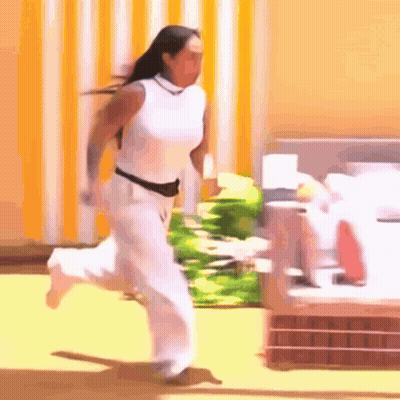 Woman In White Pants And Shirt Running GIF