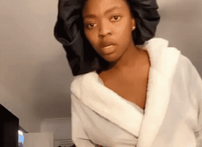 Woman In White Robe And Black Satin Bonnet GIF