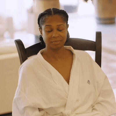 Woman In White Robe Sitting GIF