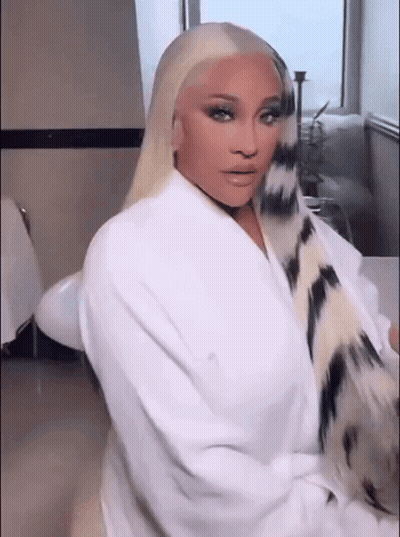 Woman In White Robe Sitting In Bathroom GIF