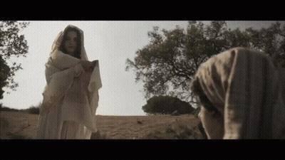 Woman In White Robe Standing In Field GIF