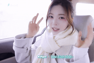 Woman In White Scarf Coat Giving Peace Sign GIF