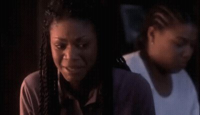 Woman In White Shirt And Black Vest In Dark Room GIF