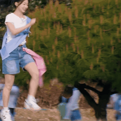 Woman In White Shirt And Blue Shorts Jumping GIF