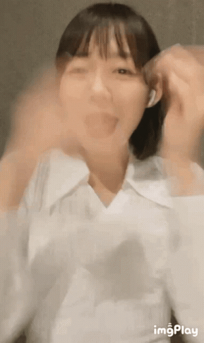 Woman In White Shirt And Headphones Making Funny Face GIF