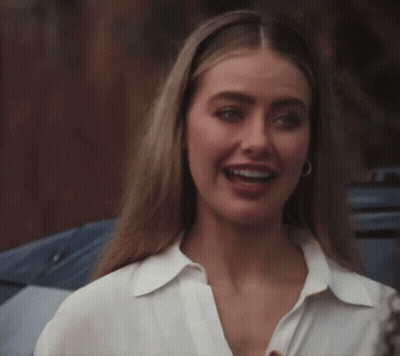Woman In White Shirt And Hoop Earrings Smiling GIF