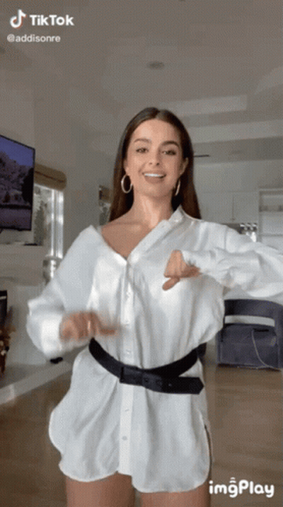 Woman In White Shirt And Shorts Dancing In Living Room GIF