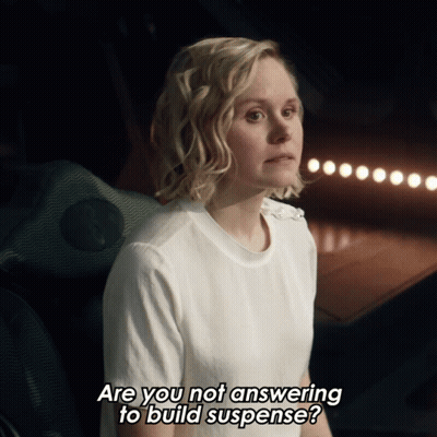 Woman In White Shirt Asking If She Is Answering To Build Suspense GIF