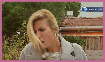 Woman In White Shirt At Table Saying E Questo GIF