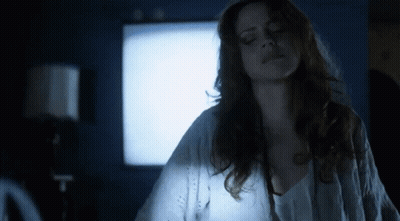 Woman In White Shirt By Blue Wall GIF