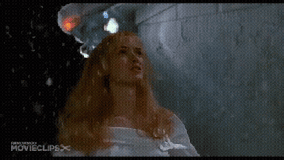 Woman In White Shirt Covering Face In Rain GIF