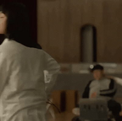 Woman In White Shirt Dancing At Microphone GIF