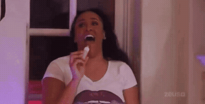 Woman In White Shirt Eating Candy Bar GIF