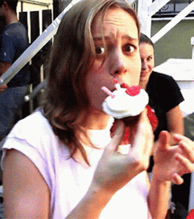 Woman In White Shirt Eating Cupcake GIF