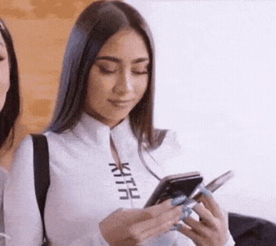 Woman In White Shirt Holding Cell Phone GIF