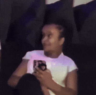 Woman in White Shirt Holding Cell Phone
