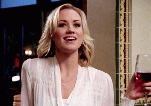 Woman In White Shirt Holding Glass Of Red Wine GIF
