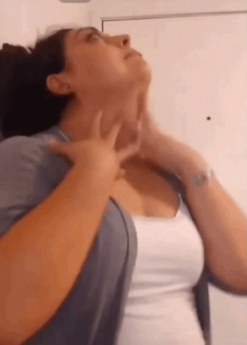 Woman In White Shirt Holding Neck GIF