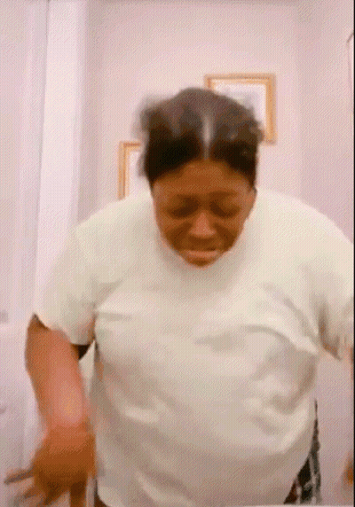 Woman In White Shirt In Front Of Mirror GIF