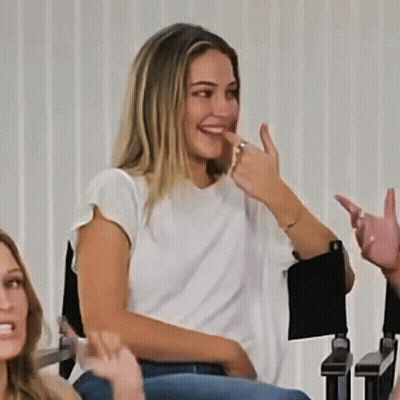 Woman In White Shirt Laughing And Giving Middle Finger GIF