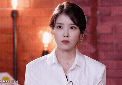 Woman In White Shirt Looking At Camera With Safe Zone GIF