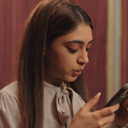Woman In White Shirt Looking At Cell Phone GIF