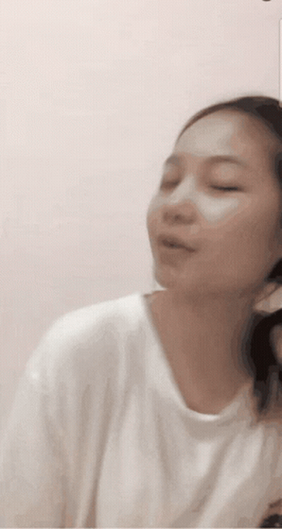 Woman In White Shirt Making Funny Face With Eyes Closed GIF