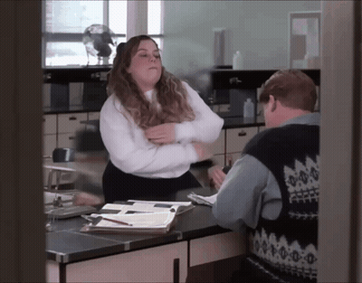 Woman In White Shirt Next To Man In Blue Vest GIF