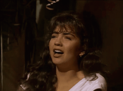 Woman In White Shirt Singing Into Microphone GIF