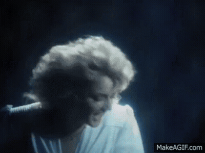 Woman In White Shirt Singing Into Microphone GIF